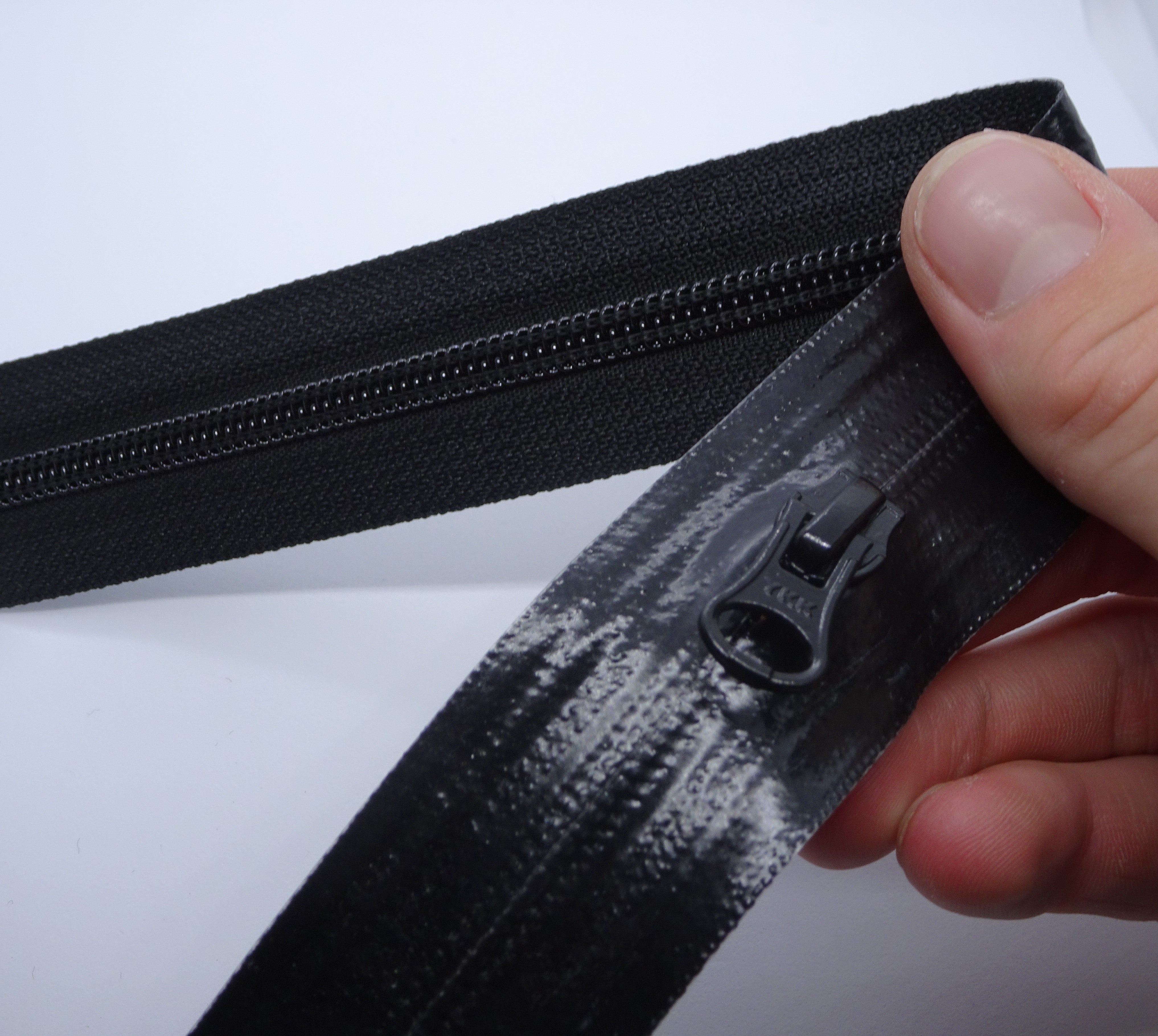 YKK's AquaGuard® NATULON® series is an eco-friendly water-repellent zipper option created by laminating polyurethane (PU) on the non-coil, reverse side of a zipper. The NATULON style is the new sustainable standard for all YKK Aquaguard products. YKK's AquaGuard® NATULON® updates include: Recycled polyester tape (which helps reduce CHG emissions) PFC free water repellant finish 20-40% smoother in operation force New smoother appearance