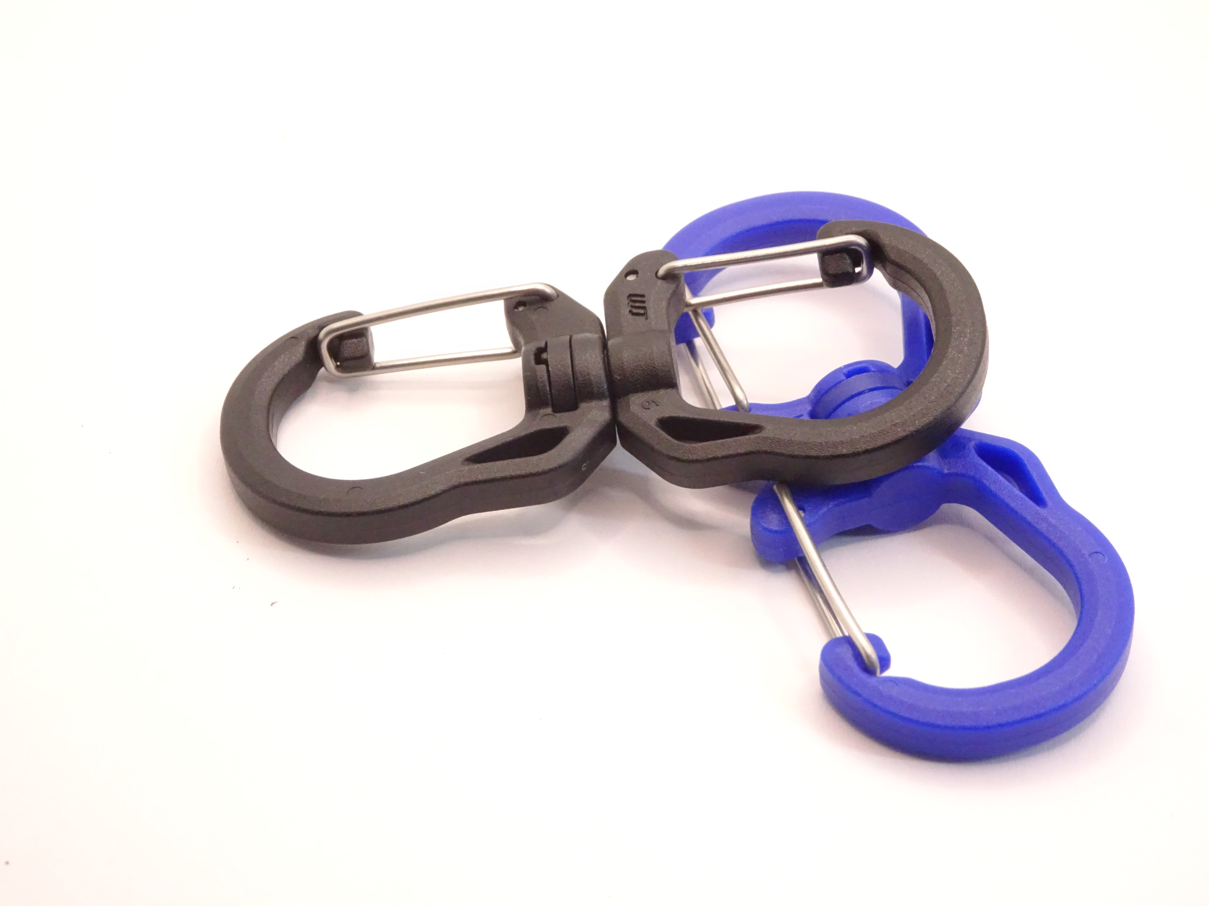 Mozet Supplies' double carabiner joined in the middle by a swivel point. Available in Small, Medium, and Large and in a variety of colors. Intended to secure lighter weight items and attach to backpacks. These are the same type as the ones from Tom Bihn!