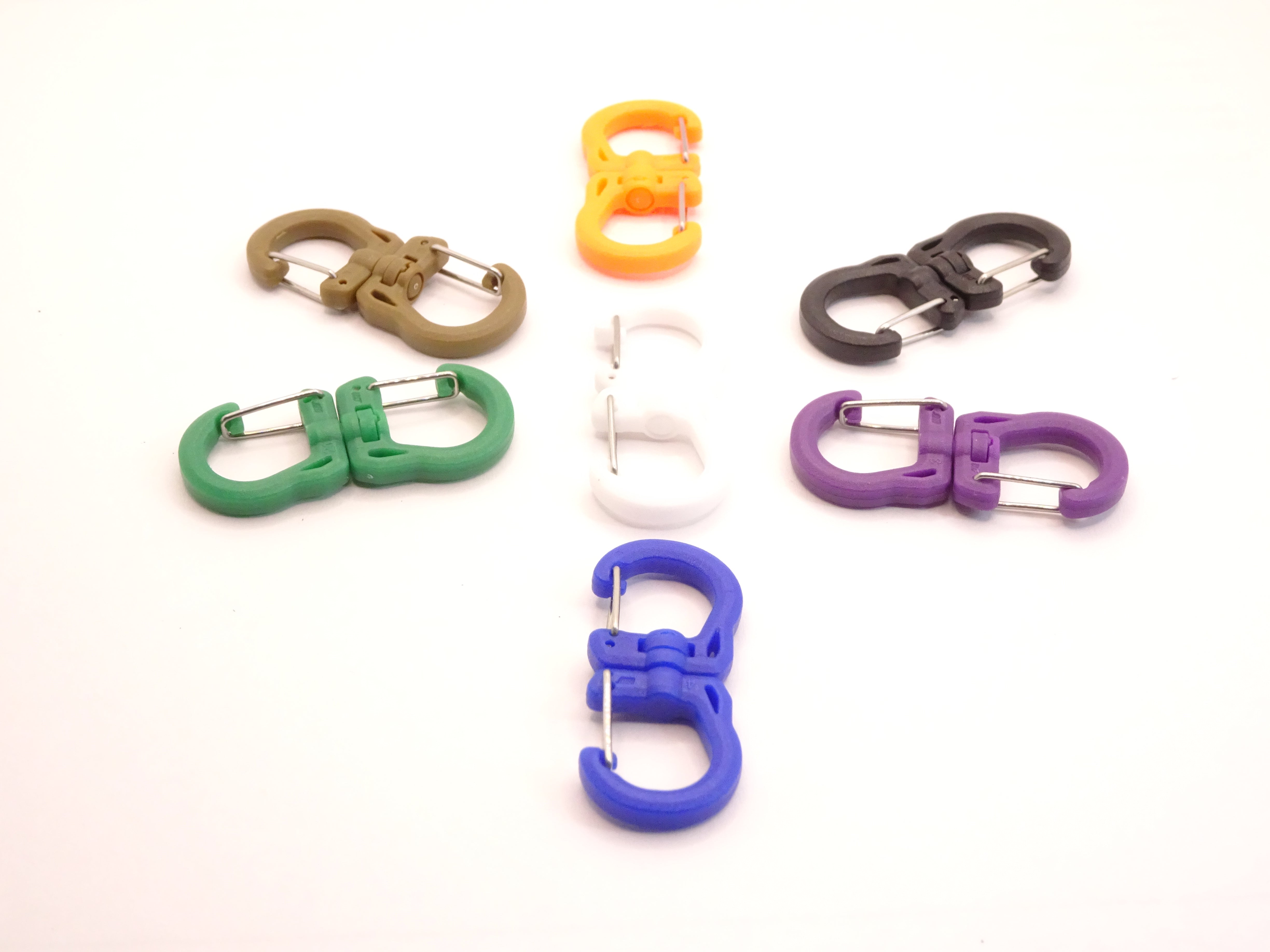 Mozet Supplies' double carabiner joined in the middle by a swivel point. Available in Small, Medium, and Large and in a variety of colors. Intended to secure lighter weight items and comes in a number of colors! These are the same type as the ones from Tom Bihn!