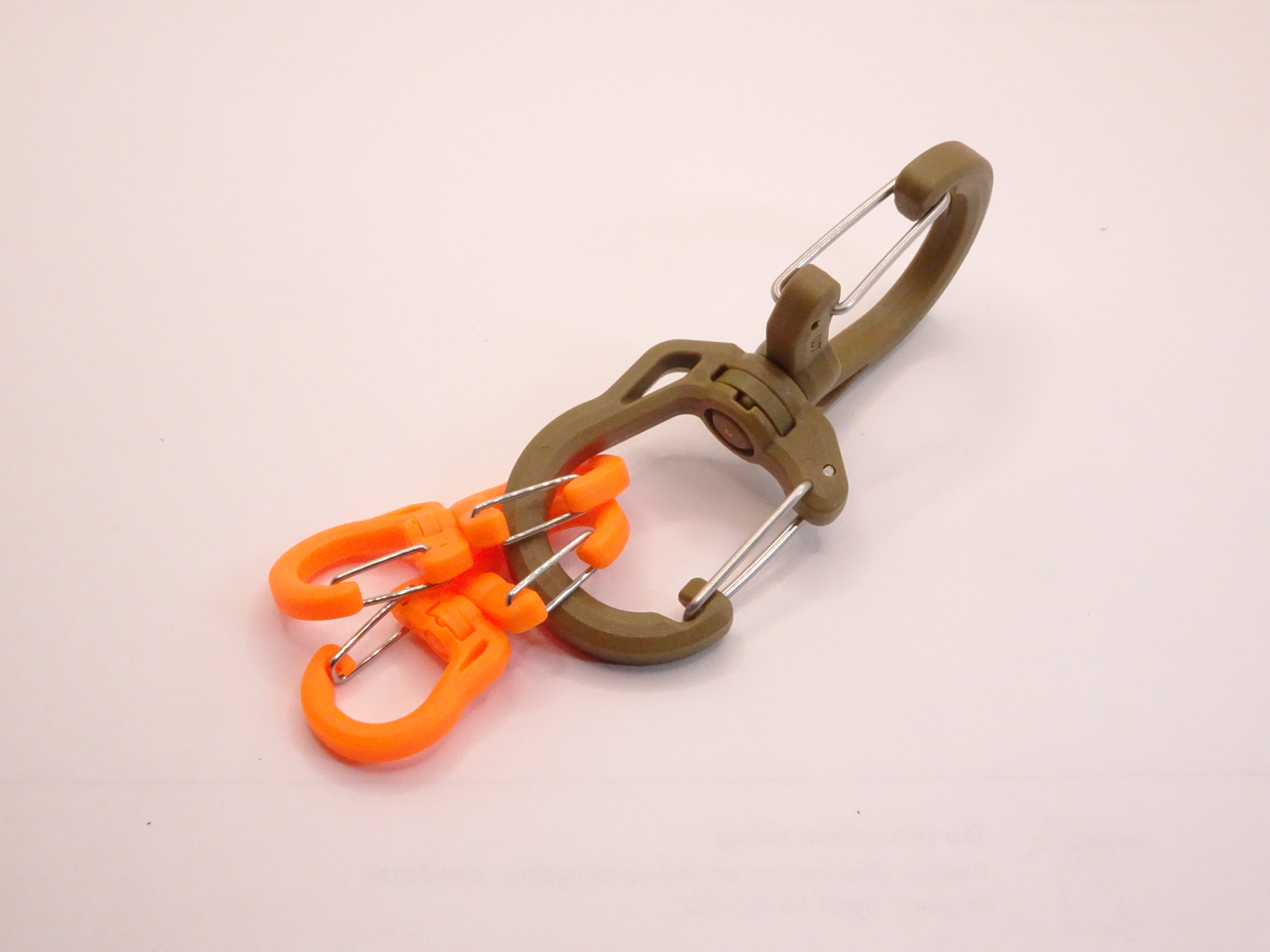 Mozet Supplies' double carabiner joined in the middle by a swivel point. Available in Small, Medium, and Large and in a variety of colors. Intended to secure lighter weight items and attach to backpacks. These are the same type as the ones from Tom Bihn!