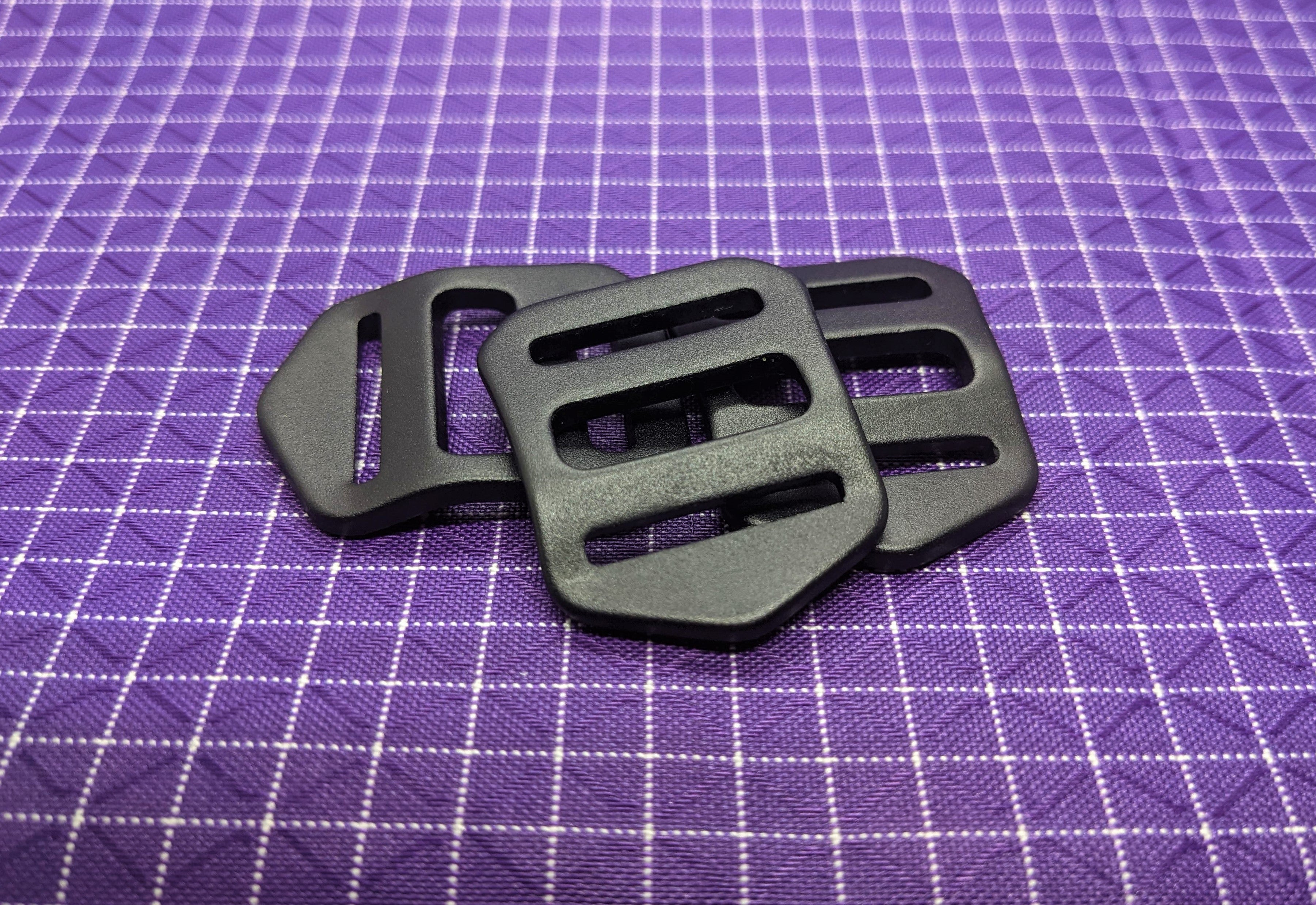 This is a high-quality, aluminum strap adjuster that is perfect for using with backpack straps. The aluminum is both strong and light!