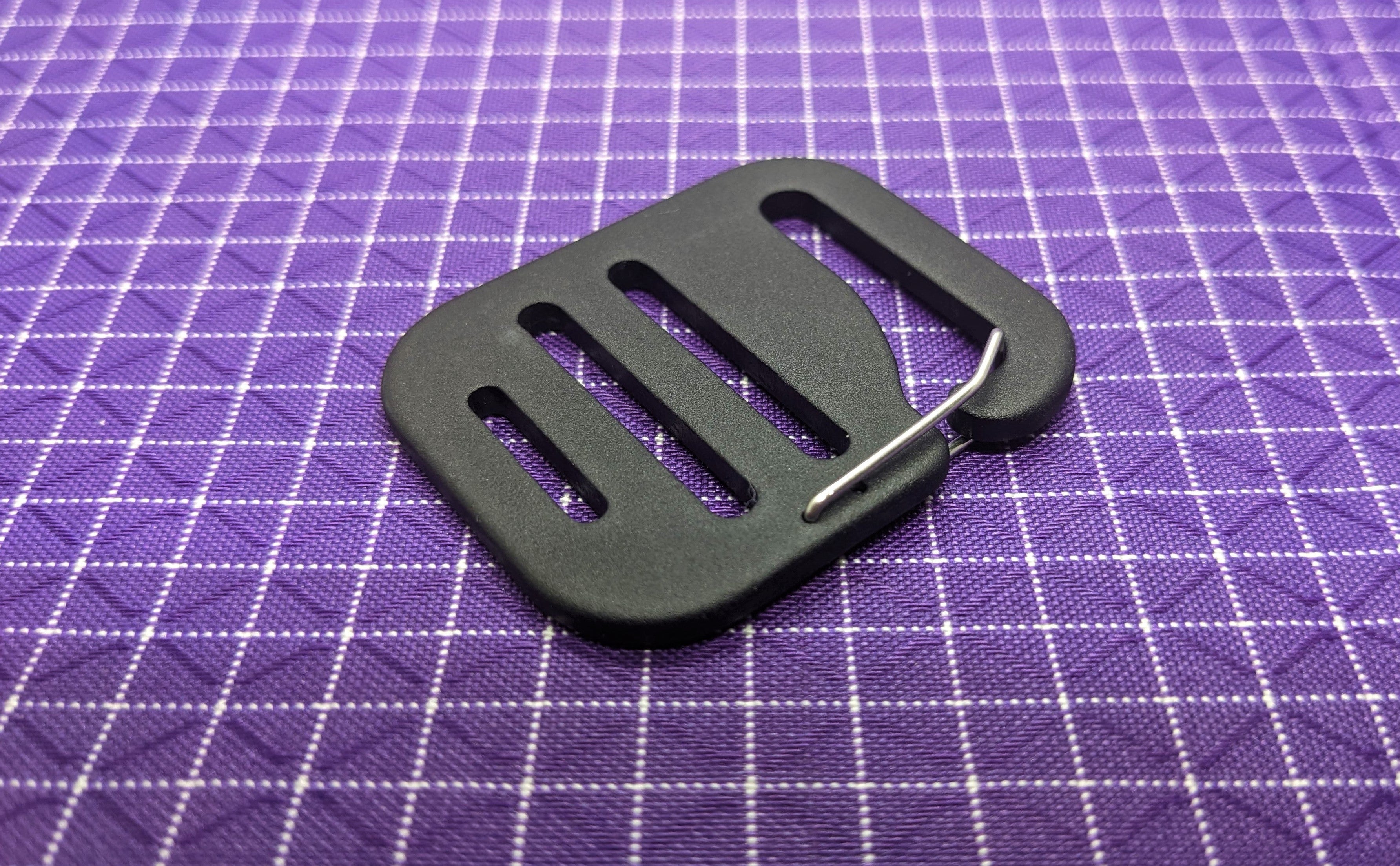 This is a high-quality, aluminum G-hook gatekeeper that can be paired with webbing strapping and used when making or modifying bags and packs. These are nice because the metal clip keeps the buckle from falling off the webbing when there is no tension to the strap.
