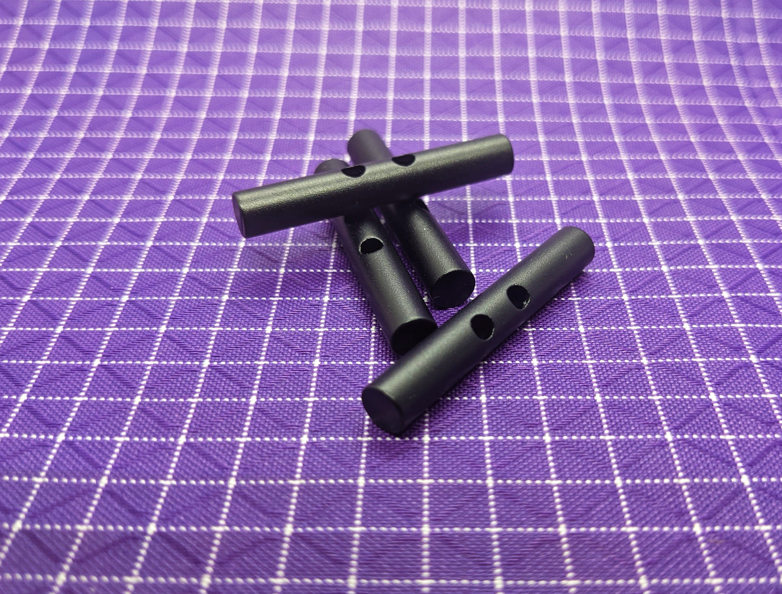 Aluminum WeTOOL Toggle that can be secured using cord and used with backpacks, tents, bags, and more! Use this when making your own gear!