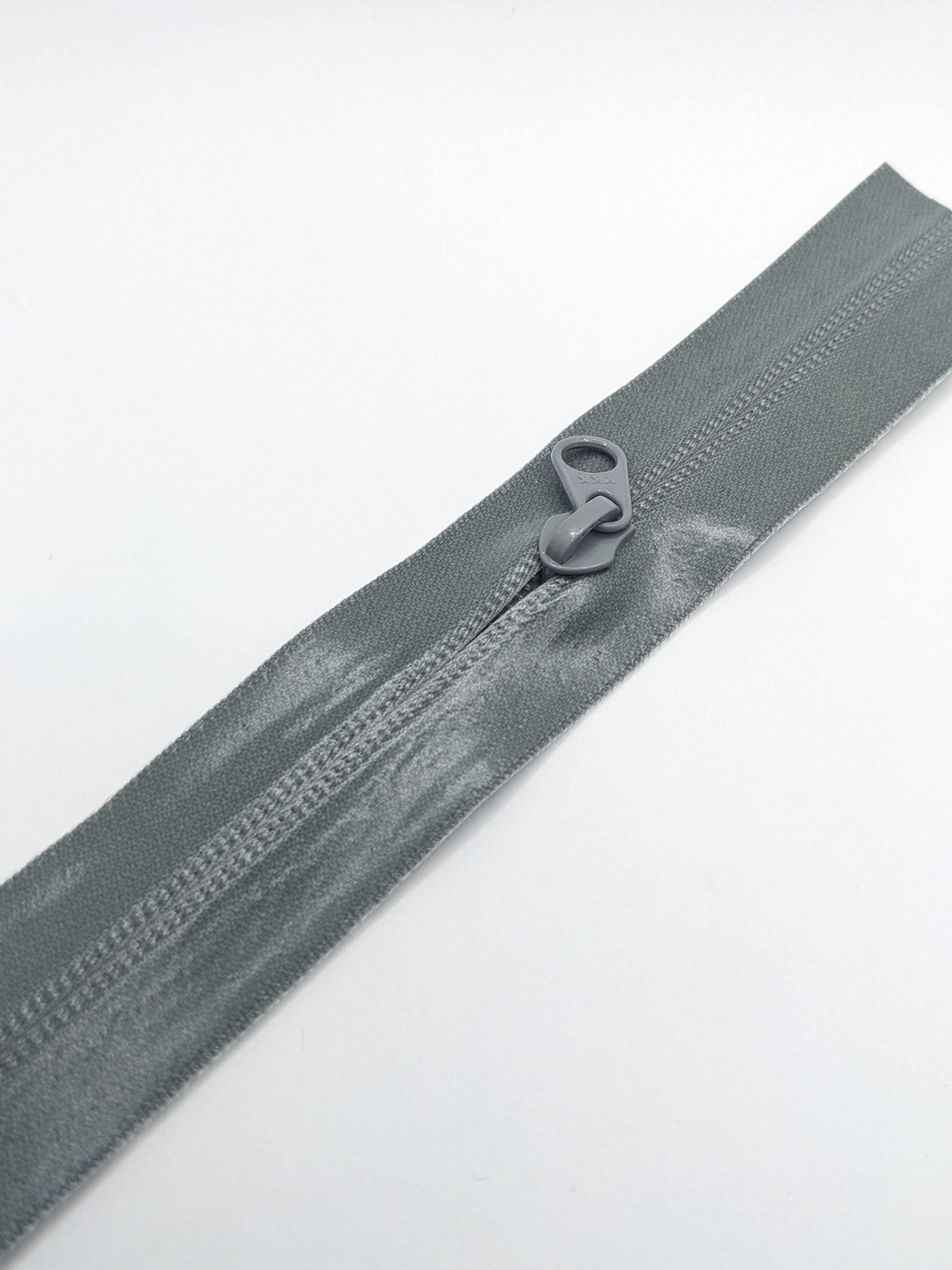 YKK's AquaGuard® NATULON® series is an eco-friendly water-repellent zipper option created by laminating polyurethane (PU) on the non-coil, reverse side of a zipper. The NATULON style is the new sustainable standard for all YKK Aquaguard products.   YKK's AquaGuard® NATULON® updates include:  Recycled polyester tape (which helps reduce CHG emissions) PFC free water repellant finish 20-40% smoother in operation force New smoother appearance