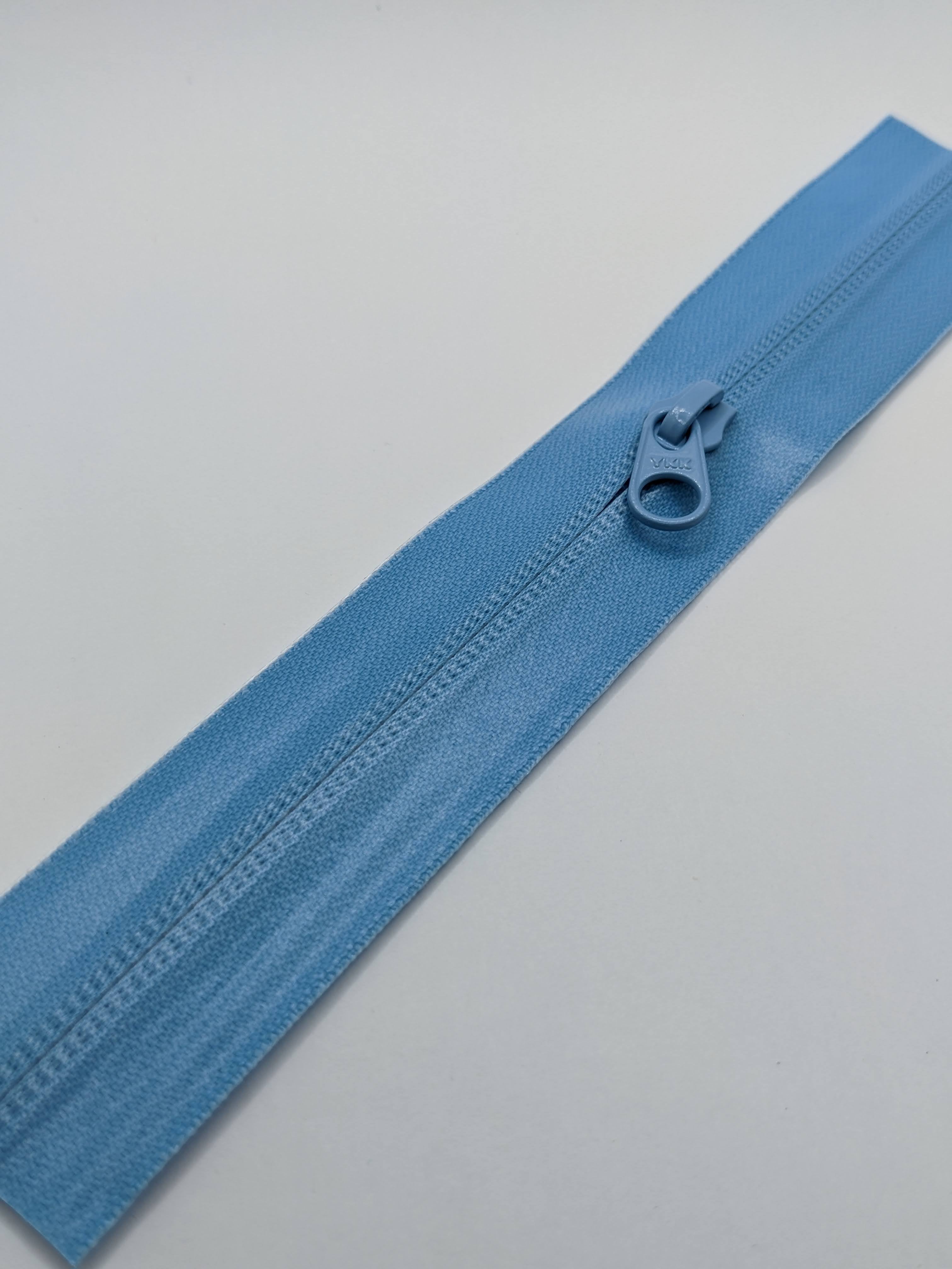 YKK's AquaGuard® NATULON® series is an eco-friendly water-repellent zipper option created by laminating polyurethane (PU) on the non-coil, reverse side of a zipper. The NATULON style is the new sustainable standard for all YKK Aquaguard products.   YKK's AquaGuard® NATULON® updates include:  Recycled polyester tape (which helps reduce CHG emissions) PFC free water repellant finish 20-40% smoother in operation force New smoother appearance