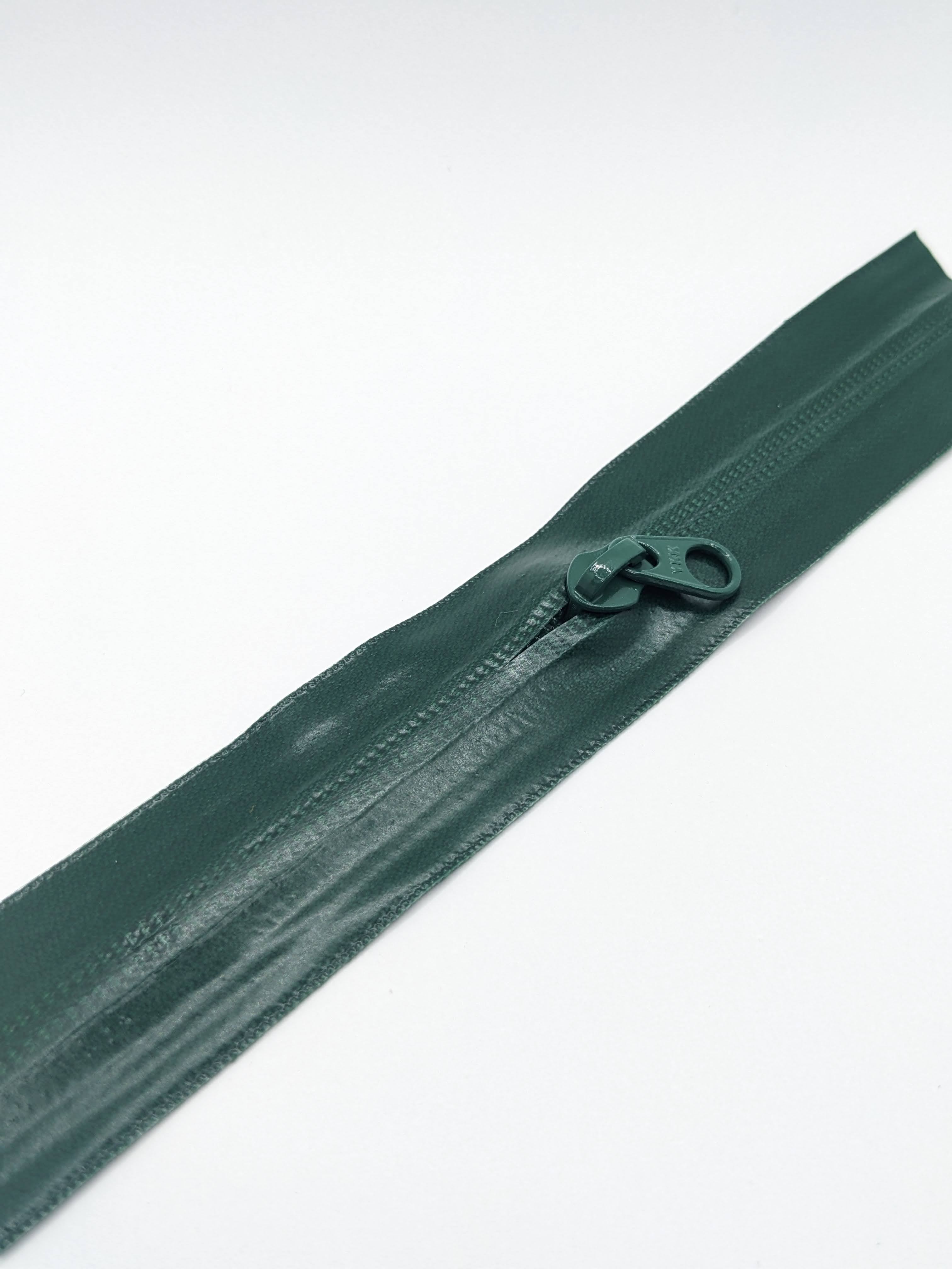 YKK's AquaGuard® NATULON® series is an eco-friendly water-repellent zipper option created by laminating polyurethane (PU) on the non-coil, reverse side of a zipper. The NATULON style is the new sustainable standard for all YKK Aquaguard products.   YKK's AquaGuard® NATULON® updates include:  Recycled polyester tape (which helps reduce CHG emissions) PFC free water repellant finish 20-40% smoother in operation force New smoother appearance