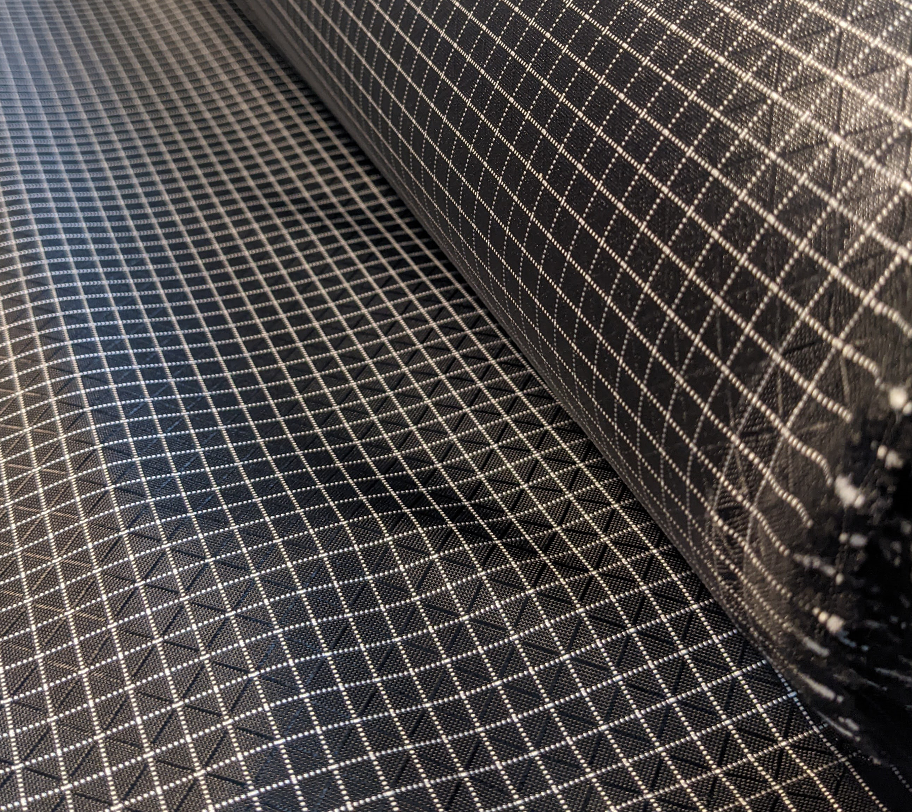 Black 210d UHMWPE Gridstop with Nylon 6.6 is some of the strongest gridstop fabric available on the market! This fabric is a step up from Ripstop By The Roll's 210d HDPE Gridstop, Robic Extreema Gridstop and is similar to Dyneema Gridstop. This fabric is waterproof with a DWR face and PU coating backside. If you want quality ripstop fabric, try this!