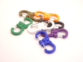 Mozet Supplies' double carabiner joined in the middle by a swivel point. Available in Small, Medium, and Large and in a variety of colors. Intended to secure lighter weight items and comes in a number of colors! These are the same type as the ones from Tom Bihn!