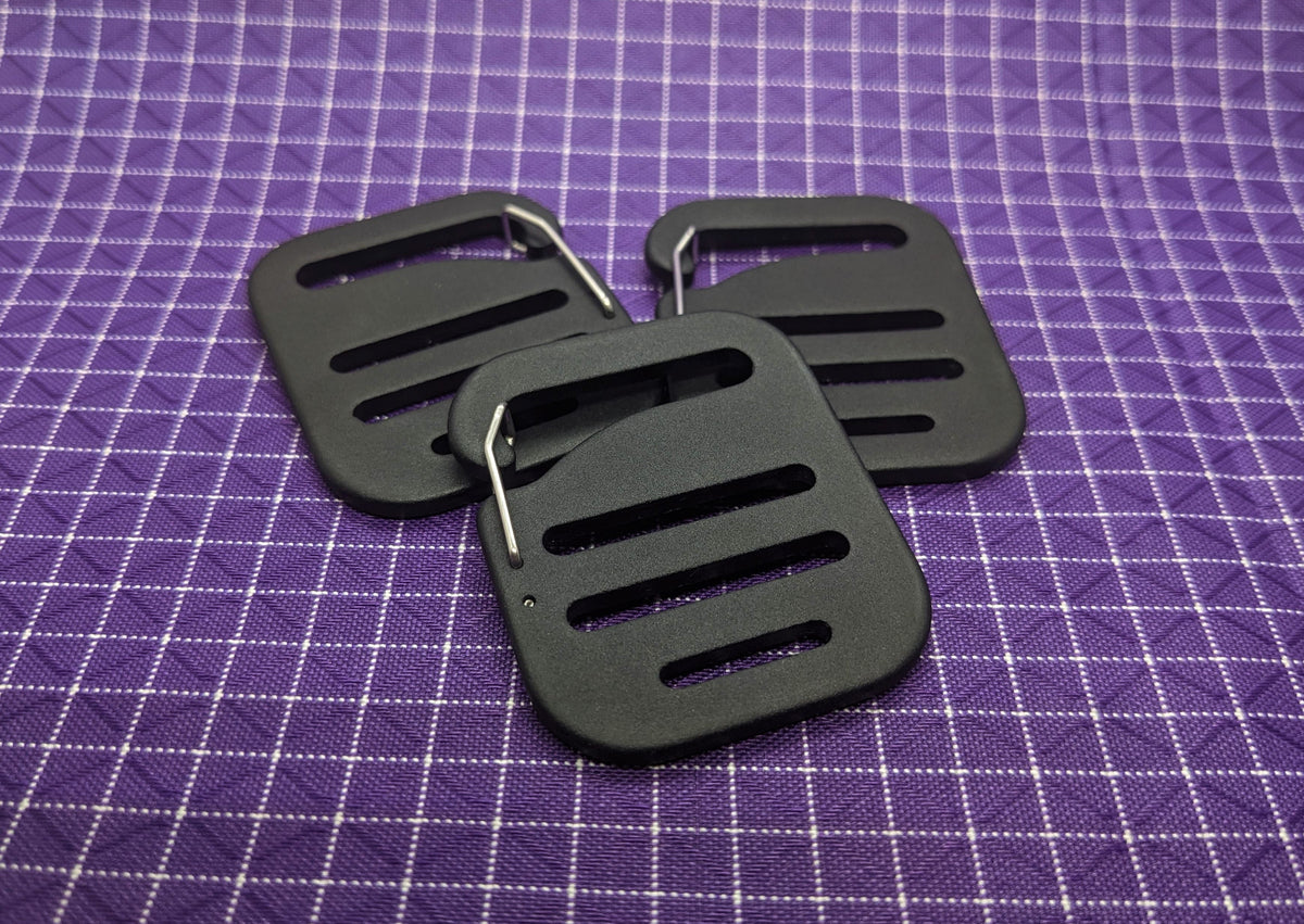 This is a high-quality, aluminum G-hook gatekeeper that can be paired with webbing strapping and used when making or modifying bags and packs. These are nice because the metal clip keeps the buckle from falling off the webbing when there is no tension to the strap.
