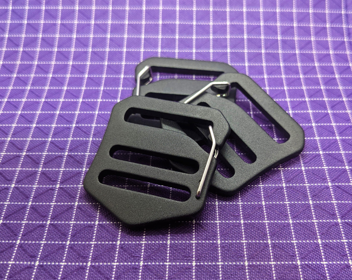 This is a high-quality, aluminum G-hook gatekeeper that can be paired with webbing strapping and used when making or modifying bags and packs. These are nice because the metal clip keeps the buckle from falling off the webbing when there is no tension to the strap.
