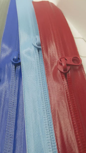 YKK's AquaGuard® NATULON® series is an eco-friendly water-repellent zipper option created by laminating polyurethane (PU) on the non-coil, reverse side of a zipper. The NATULON style is the new sustainable standard for all YKK Aquaguard products.   YKK's AquaGuard® NATULON® updates include:  Recycled polyester tape (which helps reduce CHG emissions) PFC free water repellant finish 20-40% smoother in operation force New smoother appearance